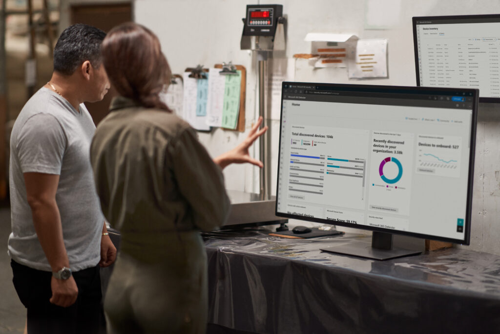 a man and a woman looking at a computer screen